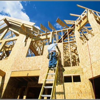 Construction worker on a ladder at a wooden construction site by Tycon Builders Inc. in San Francisco.